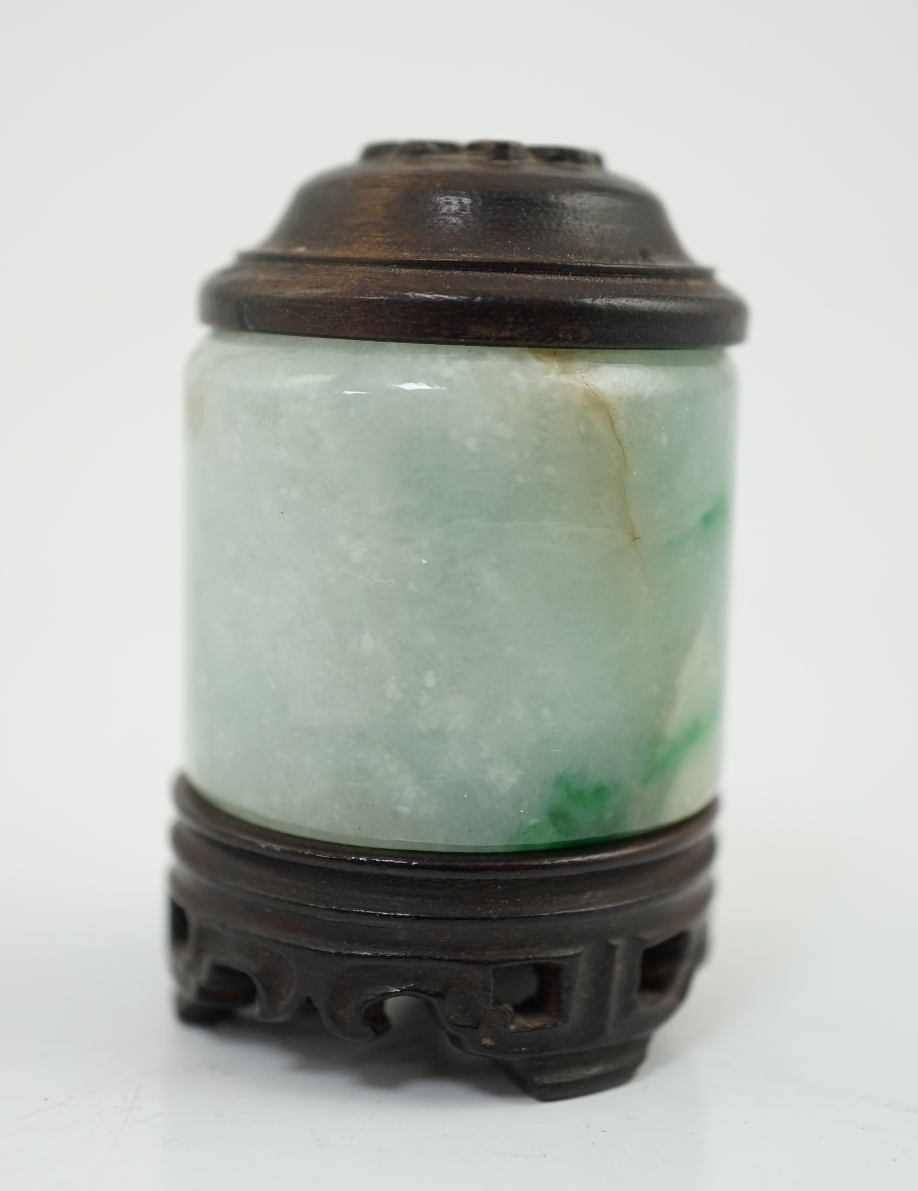 A Chinese jadeite archer's thumb ring, wood stand and cover, 19th century